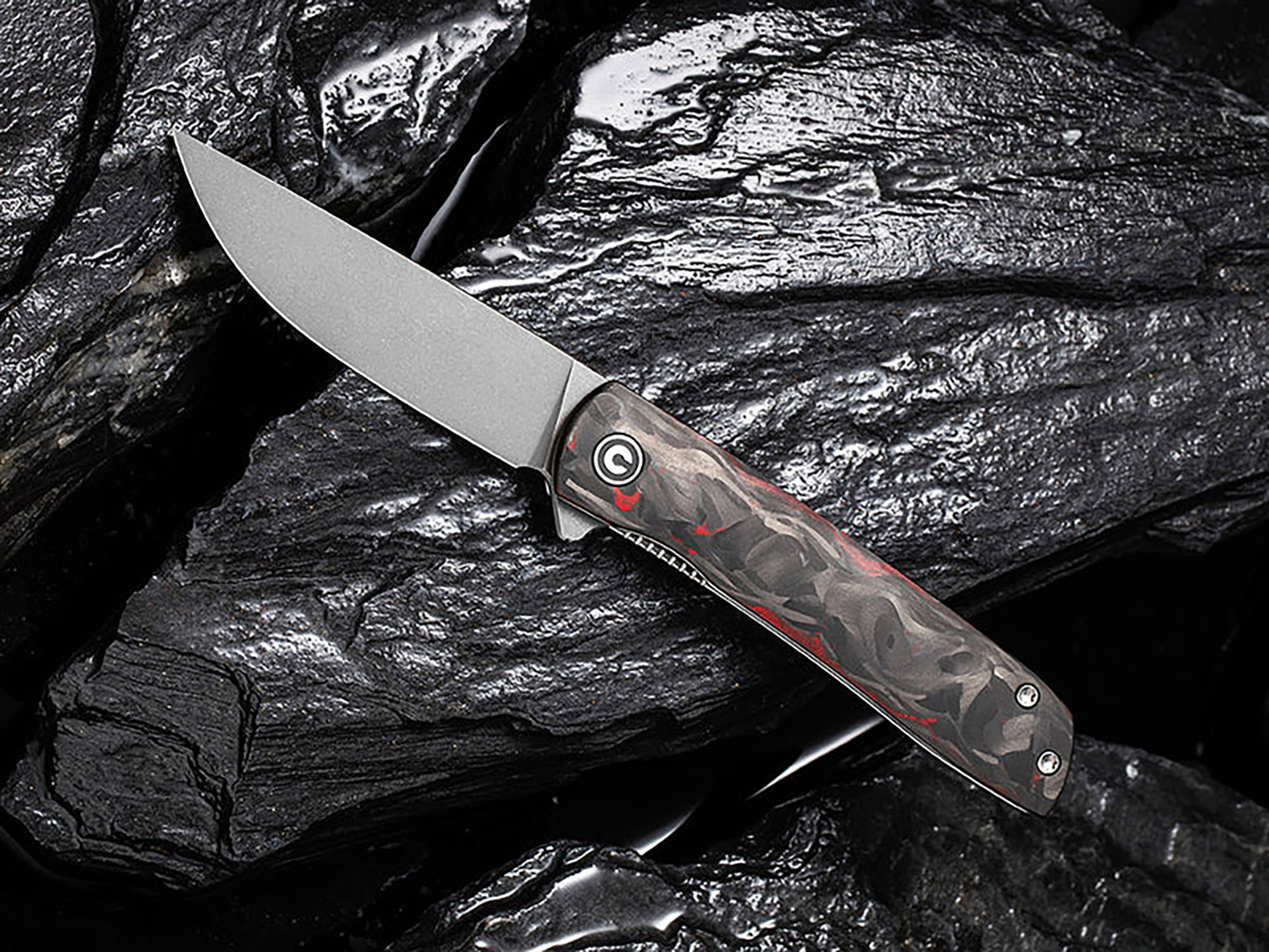 Brad Zinker Knife on display over beautiful black polished rock