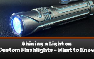 A Focusworks flashlight on a black table - a great example of custom flashlights.